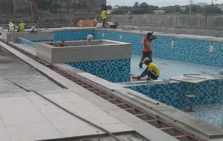 Landscape Swimming Pool Deck workers tiling