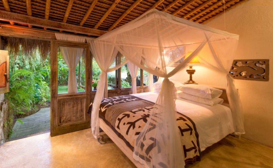 Tropical earth Color Room with curtain Beds and thatch roof warm colors